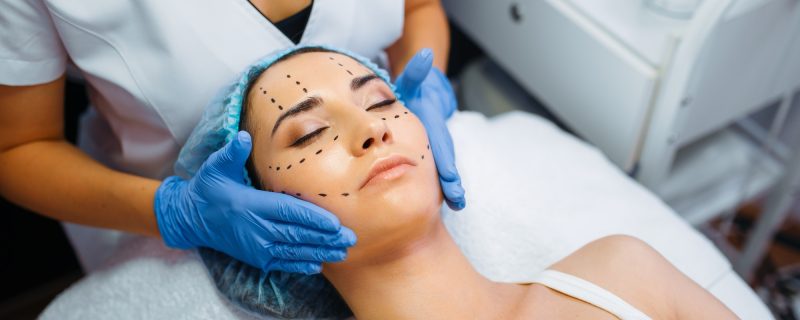 Cosmetician makes botox injection in dotted lines