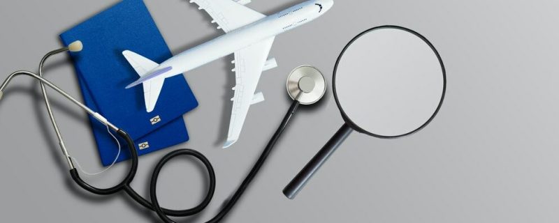 image of medical stethoscope, passport book and laptop computer.Trip and Travel insurance concept